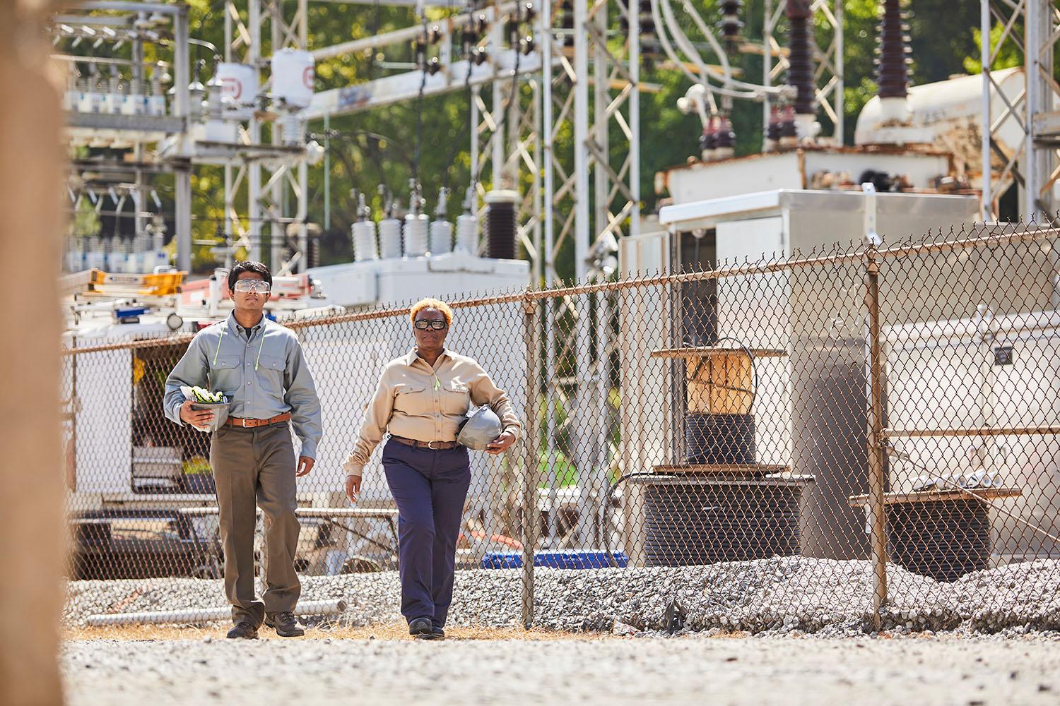 Two electrical contractors walking to work in UltraSoft uniforms.